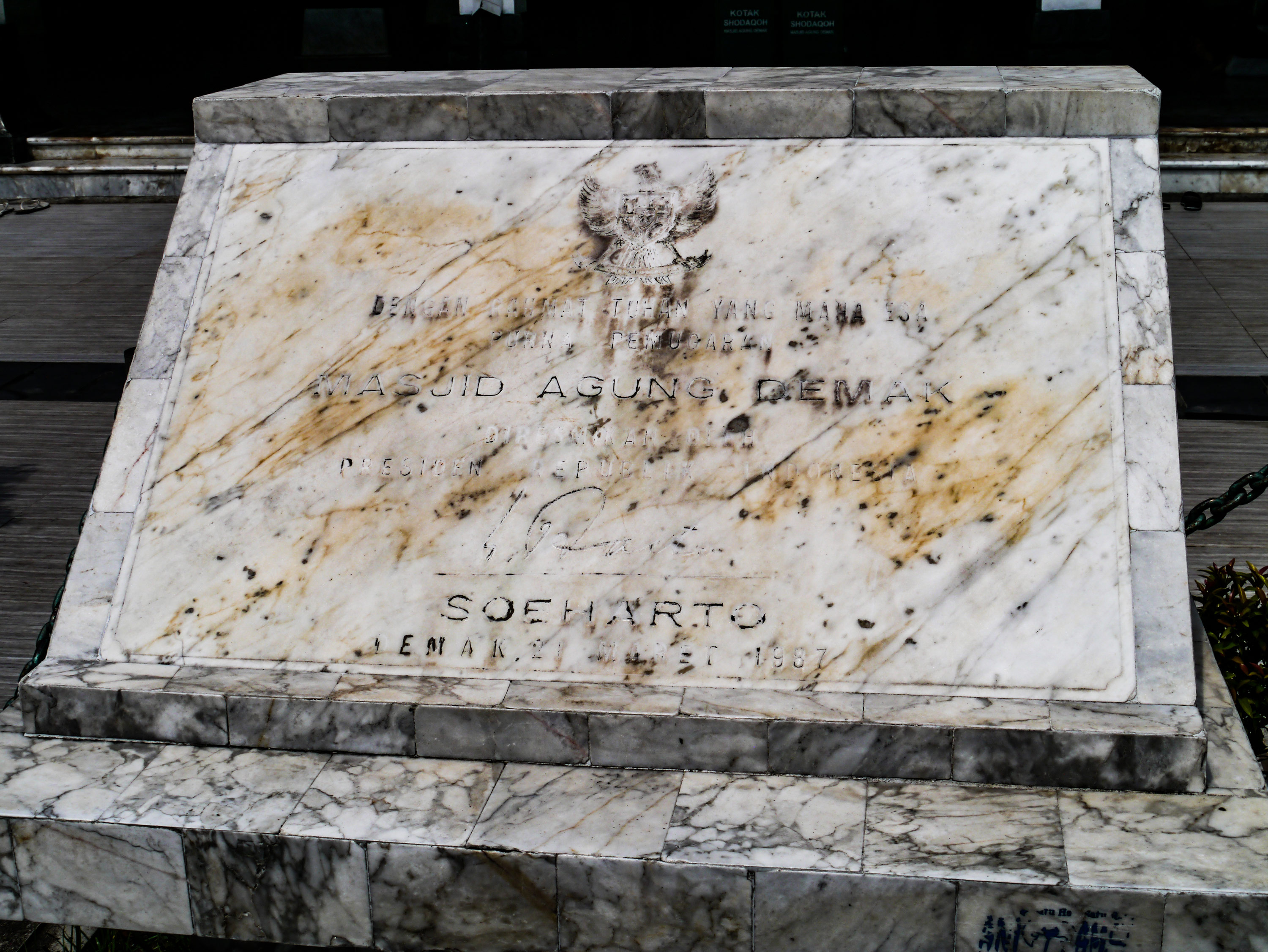 Marble plaque with fading text where the words 