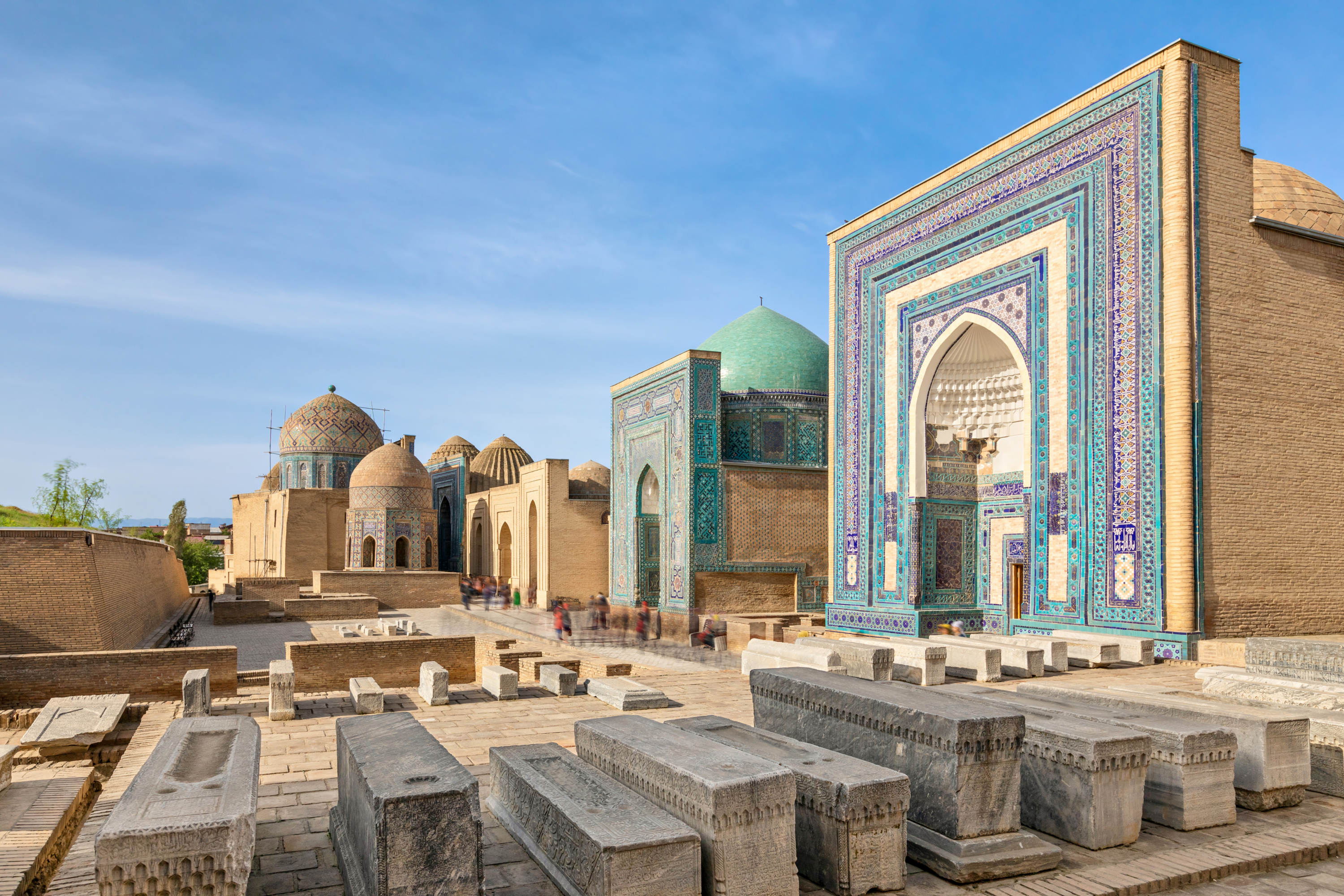 Central area at the site with colorful decorated doorways and domed buildings in the background.